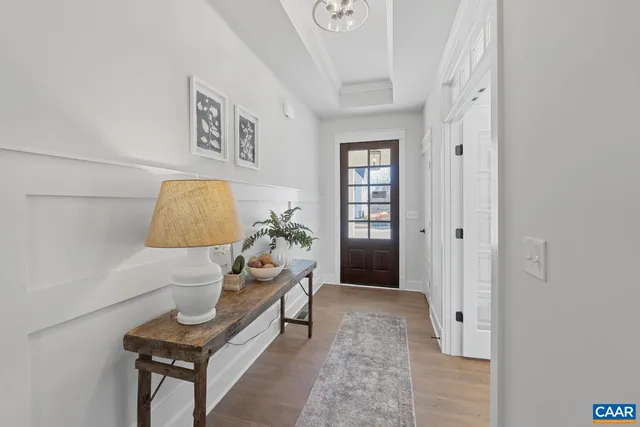 a living room with furniture and a painting on the wall