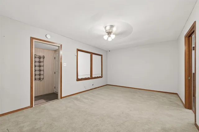 an empty room with windows and closet