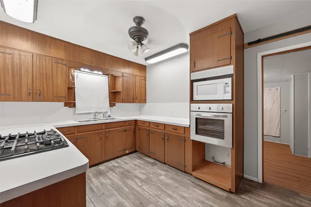 a kitchen with stove a sink and refrigerator