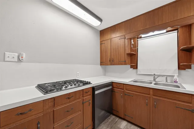 a kitchen with sink and cabinets