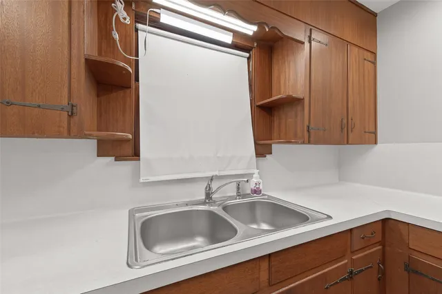 a kitchen with a sink and cabinets