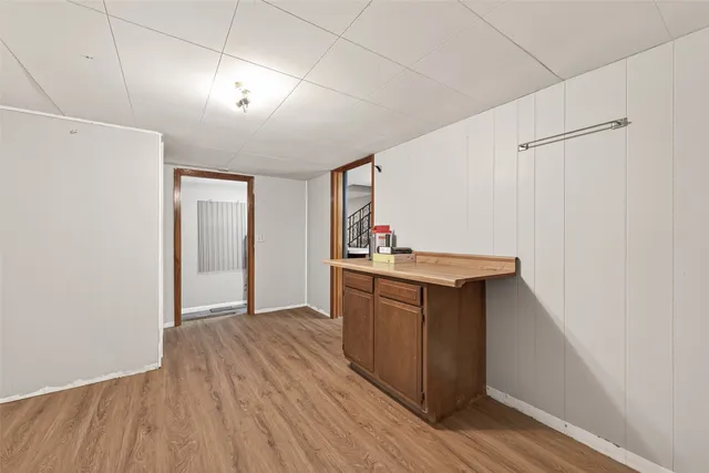 a kitchen with kitchen island white cabinets and wooden floor