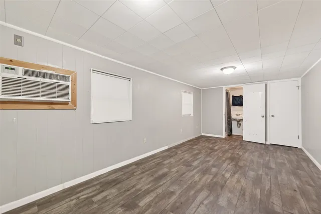 a view of empty room with wooden floor and entryway