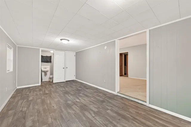 a view of empty room with wooden floor