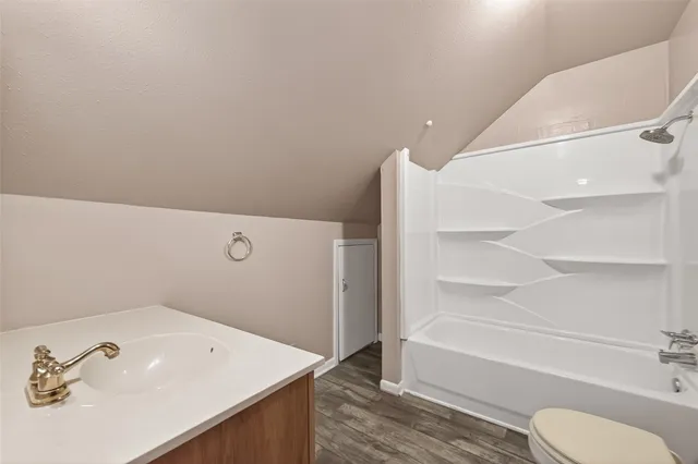 a bathroom with a sink a toilet and tub