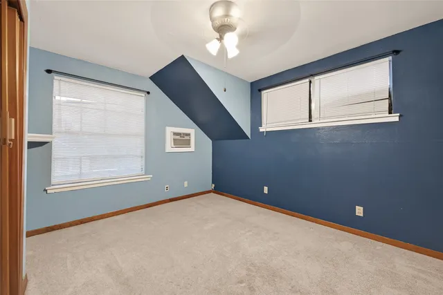 an empty room with windows and closet