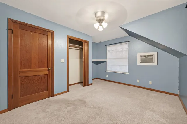 an empty room with windows and closet