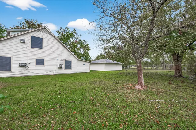 a view of a backyard with large trees