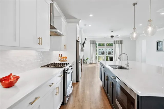 a kitchen with stainless steel appliances granite countertop a stove and a refrigerator