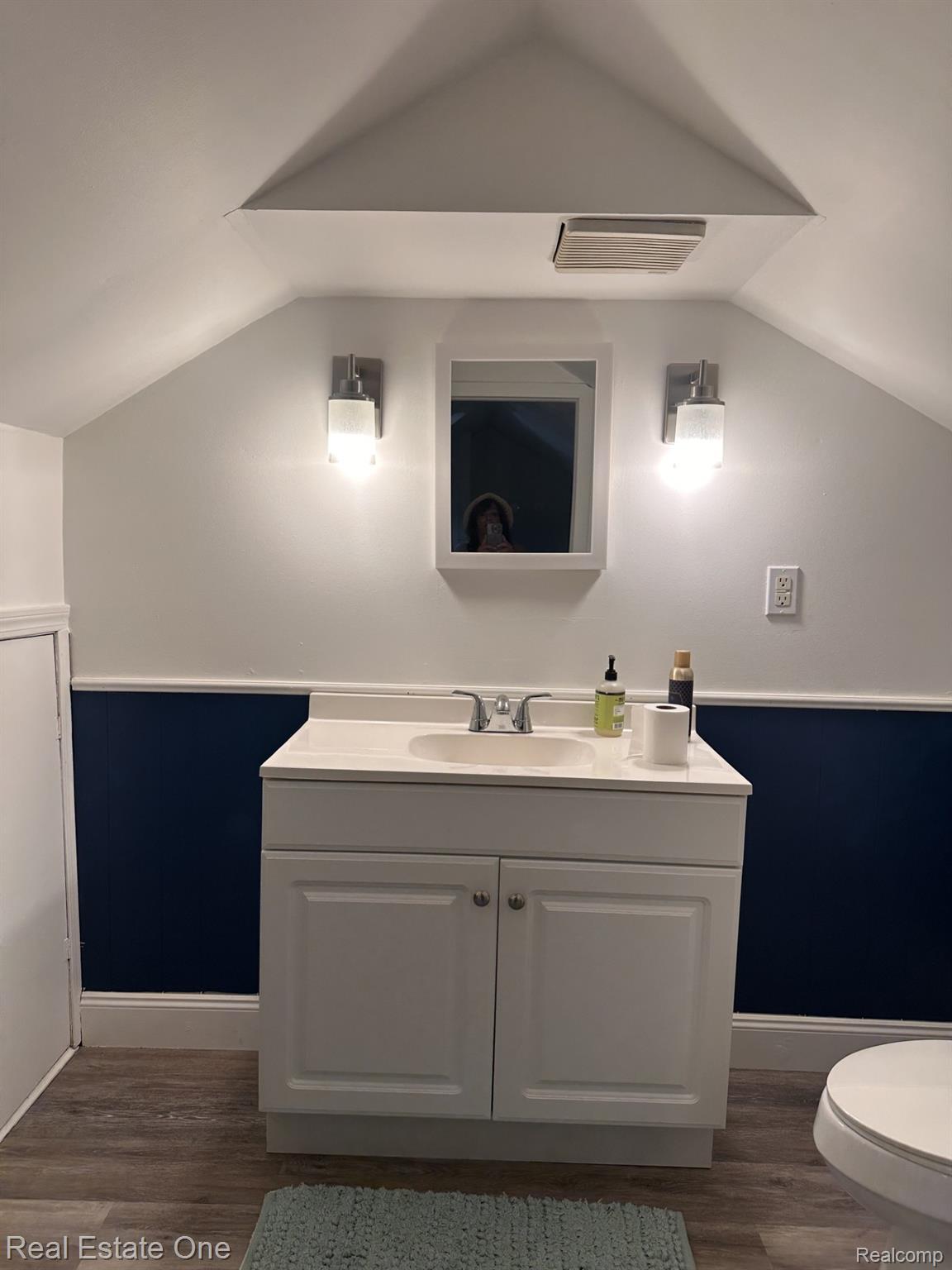 2073 Roslyn Road Grosse Pointe, MI 48236 - Photo 22 of 30 Bathroom vanity featuring a white cabinet, integrated sink, and brushed nickel faucet