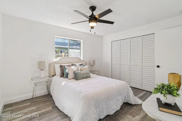 a bedroom with a bed and a potted plant