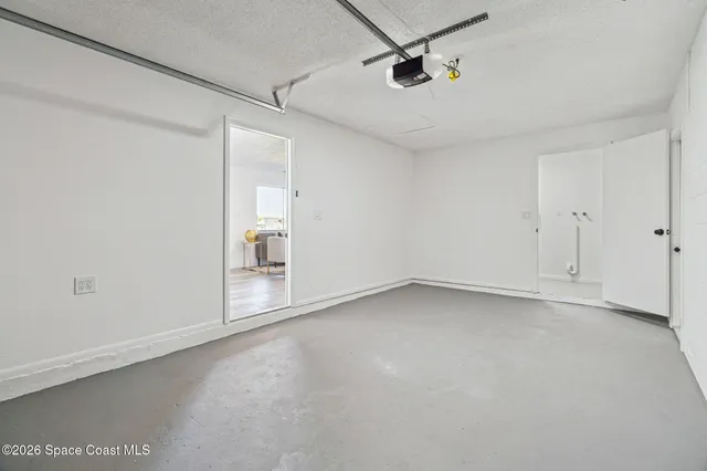 a view of a room with window and a ceiling fan