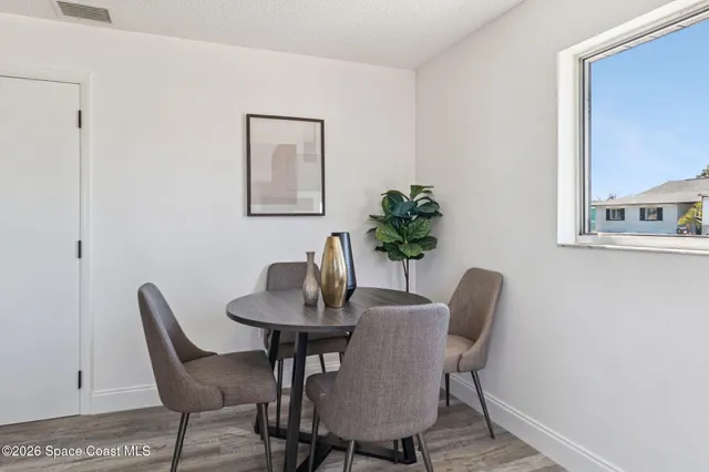 a dining room with furniture and wooden floor
