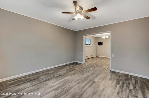 a view of room with a ceiling fan and window