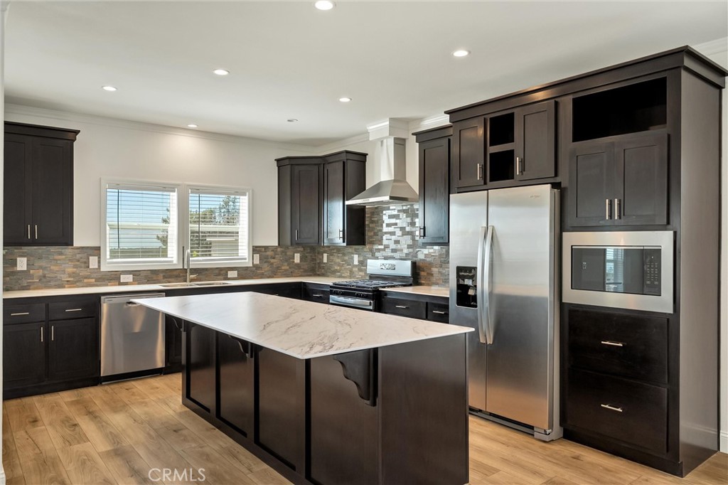 4333 Pentz Road, Unit 30 Paradise, CA 95969 - Photo 11 of 29 a large kitchen with stainless steel appliances kitchen island granite countertop a refrigerator and a sink