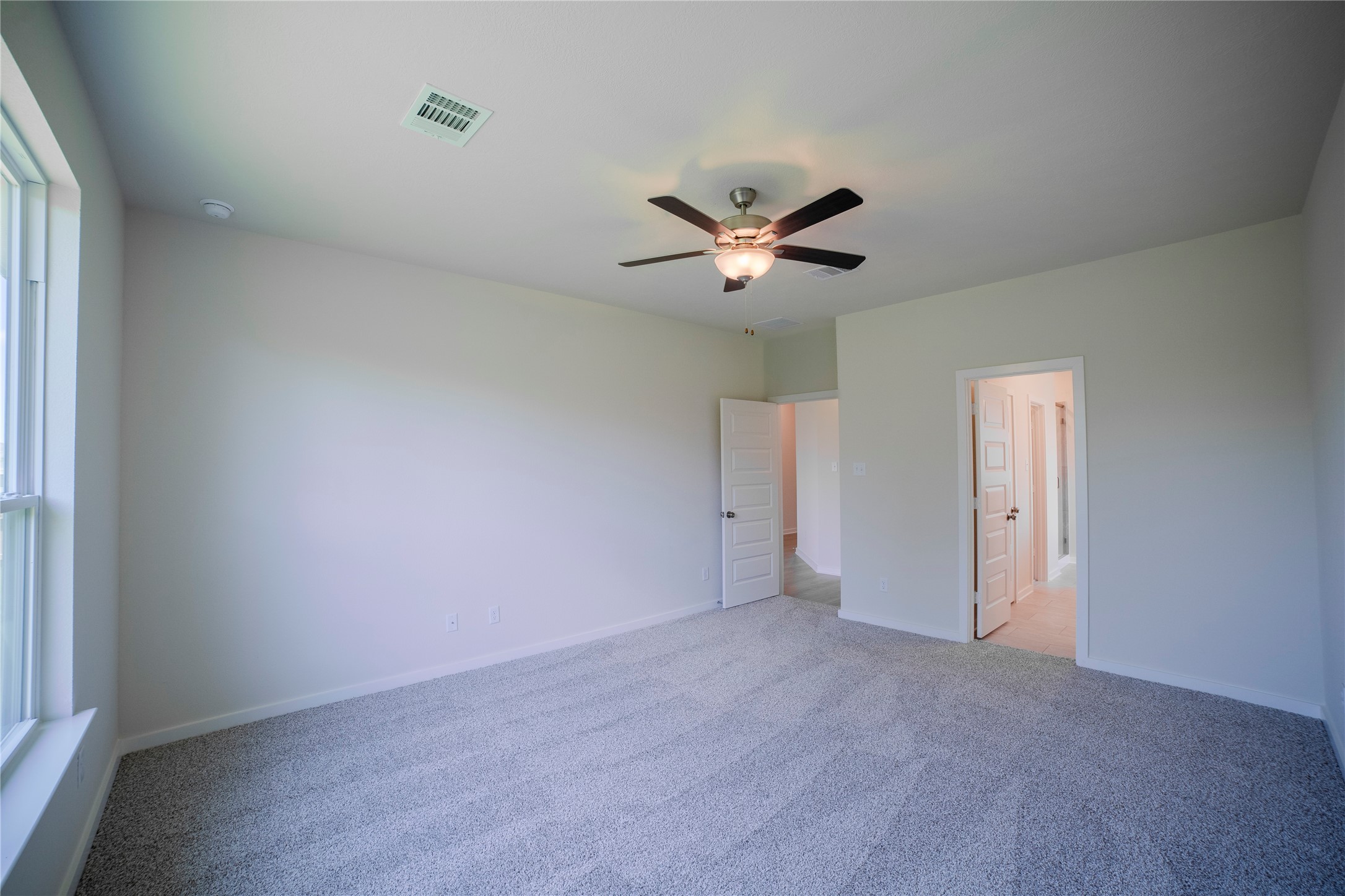 1402 Lk Rdg Drive Brenham, TX 77833 - Photo 25 of 35 an empty room with a window and a fan