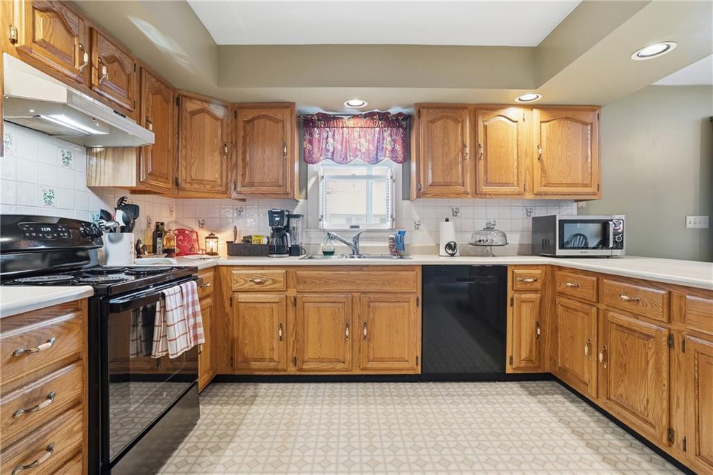 202 Holyoke Road Butler, PA 16001 - Photo 11 of 49 a kitchen with stainless steel appliances granite countertop a sink a stove a refrigerator cabinets and a window