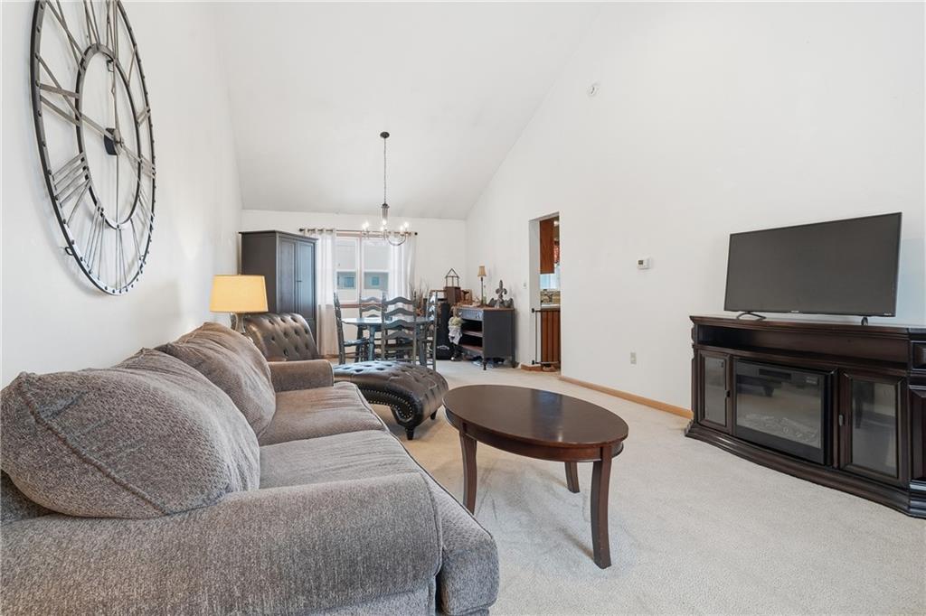 202 Holyoke Road Butler, PA 16001 - Photo 19 of 49 a living room with furniture a flat screen tv and a fireplace