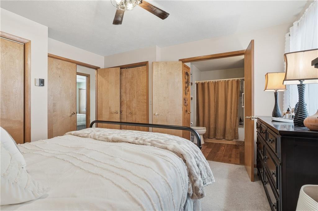 202 Holyoke Road Butler, PA 16001 - Photo 32 of 49 a bedroom with a bed a dresser and potted plants