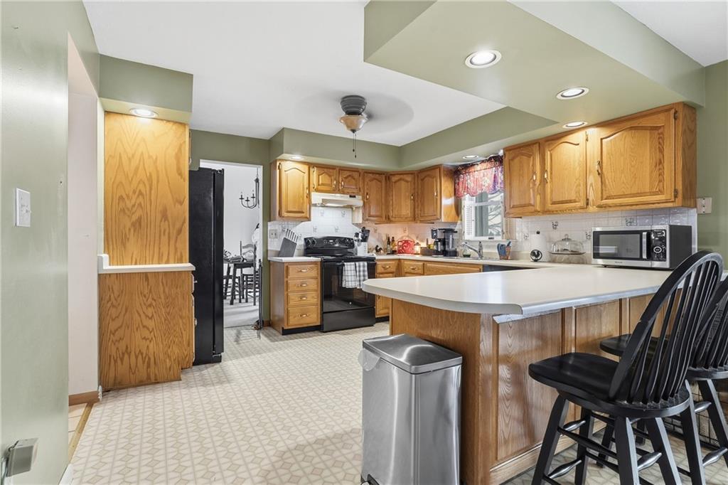 202 Holyoke Road Butler, PA 16001 - Photo 9 of 49 a kitchen with stainless steel appliances granite countertop a refrigerator a sink a stove and a center island