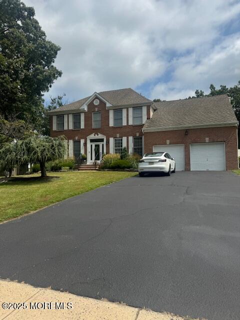 a front view of a house with a garden and yard