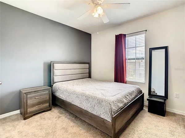 a bedroom with a large bed and a chandelier