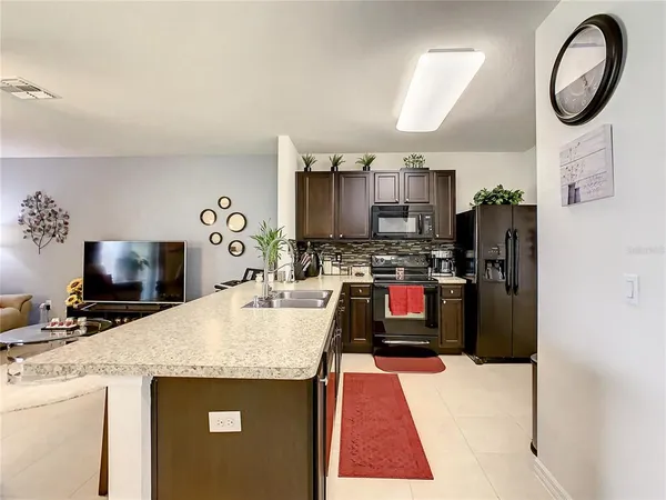 a kitchen with stainless steel appliances granite countertop a refrigerator and a stove