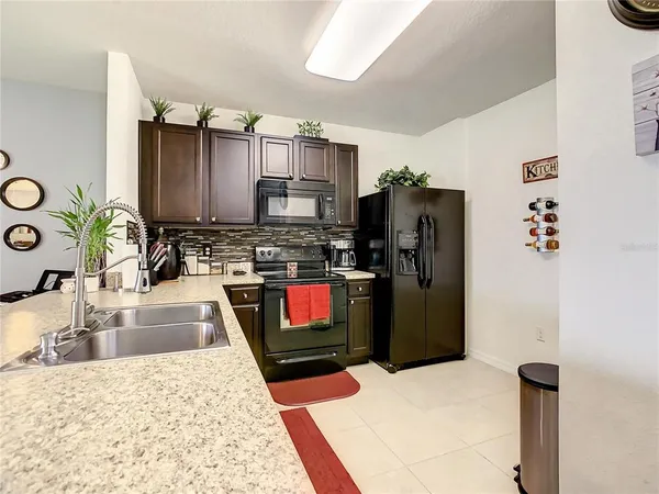 a kitchen with stainless steel appliances granite countertop a stove and a microwave