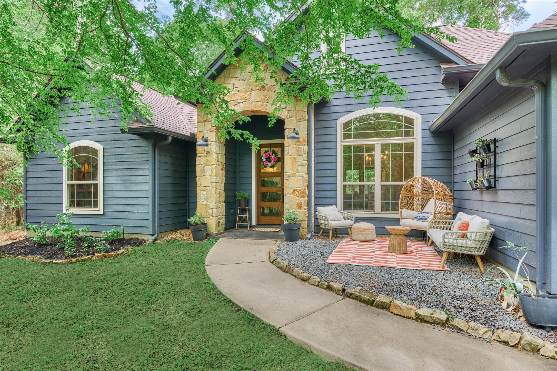 Charming front entry with stone covered front porch.