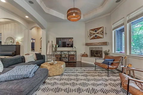 a living room with furniture a fireplace and a flat screen tv