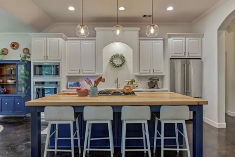 a dining table with chairs and cabinets