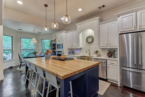 a kitchen with wooden cabinets and white appliances