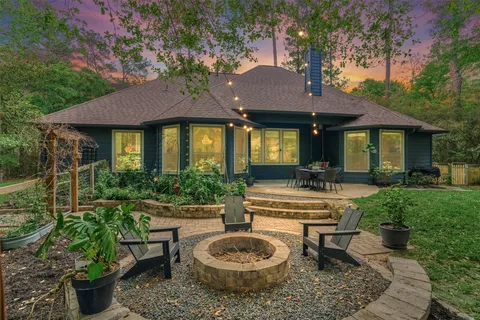 a view of a house with patio and a garden