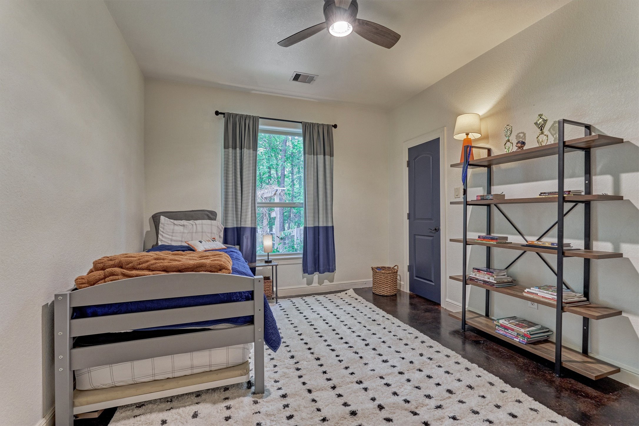 16727 Boothill Road Stagecoach, TX 77355 - Photo 24 of 44 Spacious secondary bedroom #1 features a ceiling fan and closet.