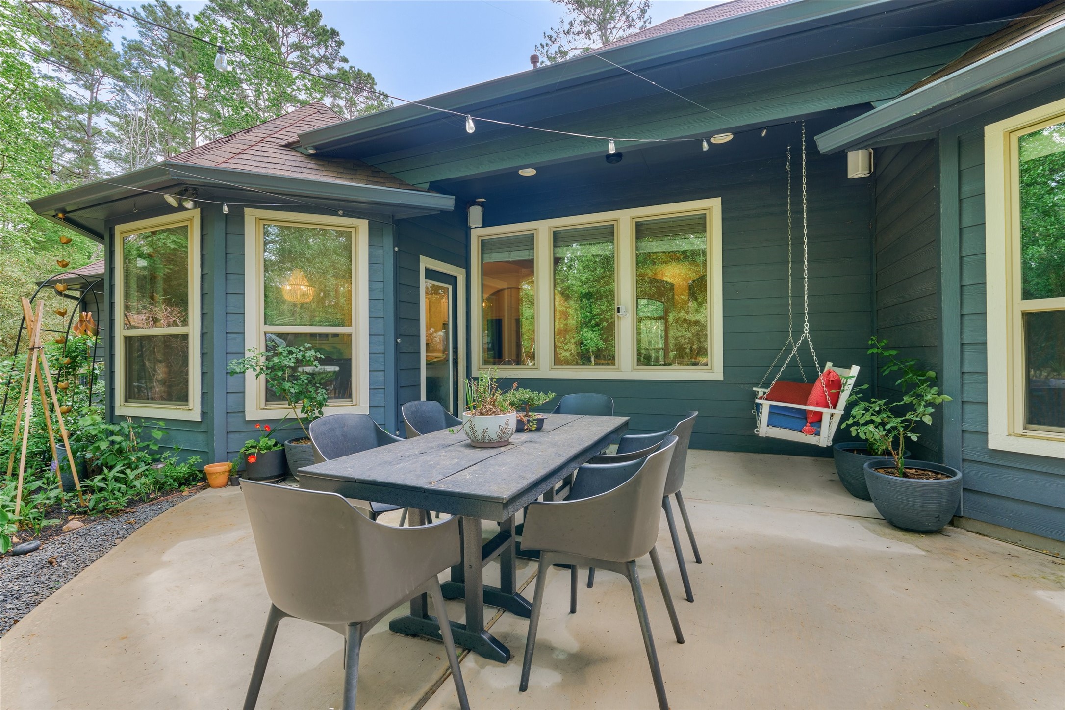 16727 Boothill Road Stagecoach, TX 77355 - Photo 29 of 44 Step outside to the serene backyard patio! Note: the covered portion has a porch swing attachment.