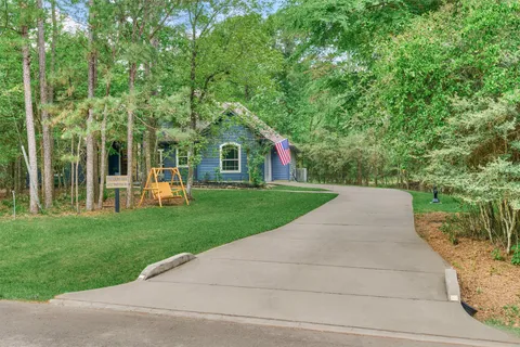 a view of a wooden chairs and a yard in the back