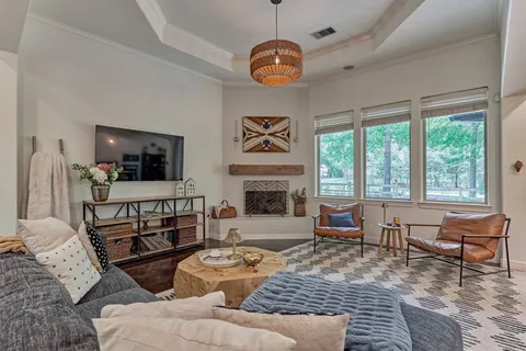 a living room with furniture a flat screen tv and a fireplace