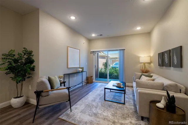 a living room with furniture and a potted plant
