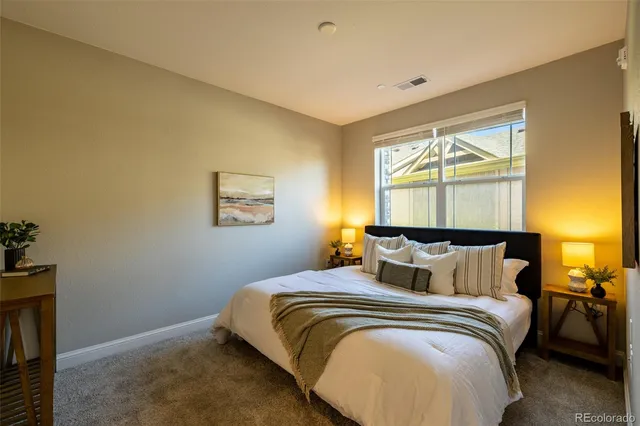 a bathroom with a granite countertop sink a toilet and a mirror