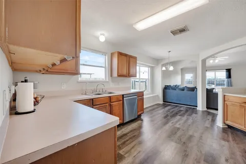 a kitchen with sink a refrigerator and cabinets