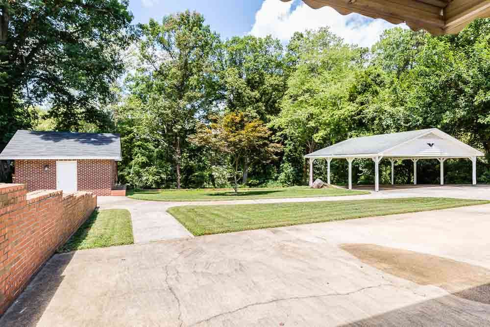 1318 Kent Road Raleigh, NC 27606 - Photo 5 of 28 Looking from patio toward carport. Storage shed on left. Looking from patio toward carport. Storage shed on left.