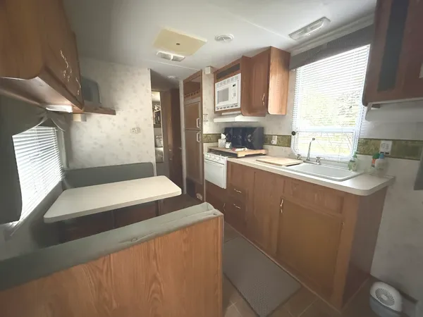a kitchen with a sink a stove a refrigerator and cabinets