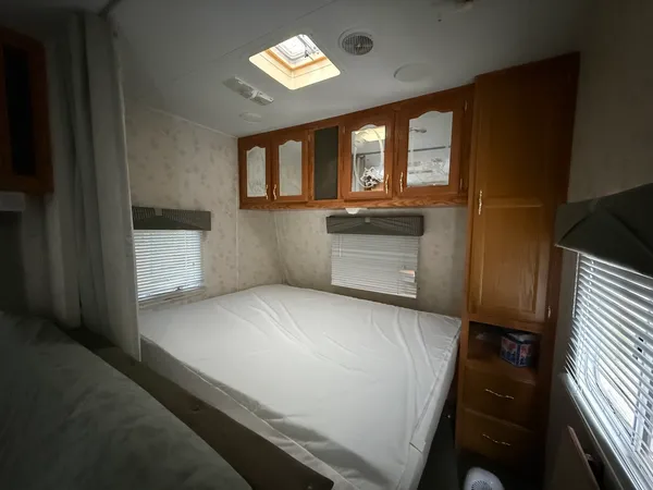 a living room with a couch and a dresser next to a window