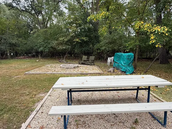 a view of a backyard with sitting area