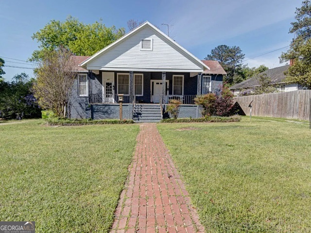 917 Oakview Avenue, Unit E Columbus, GA 31906 - Photo 1 of 13 a patio with wooden table and chairs