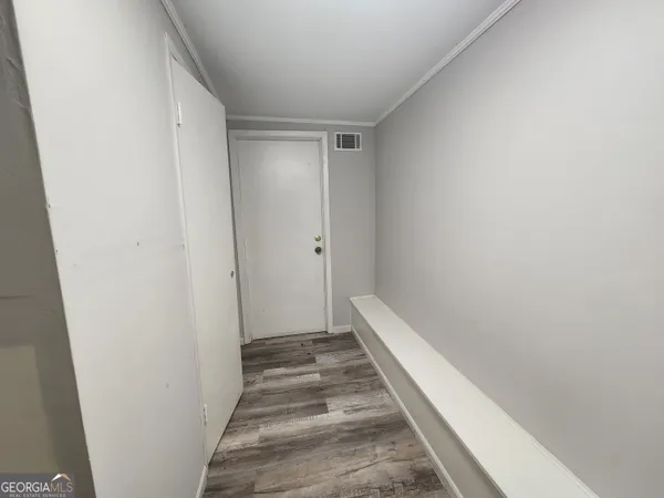 a view of a hallway with wooden floor