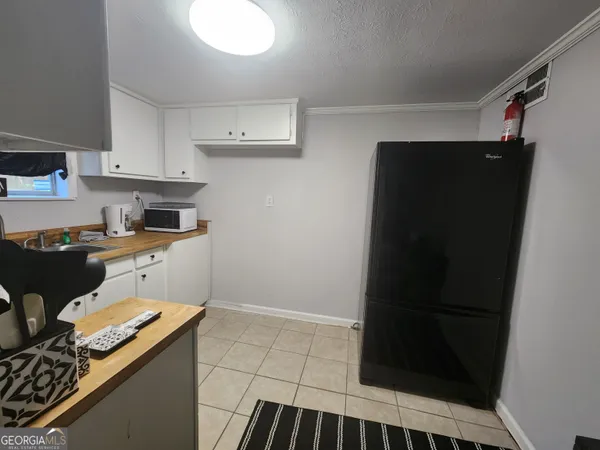 a kitchen with a refrigerator and a stove top oven