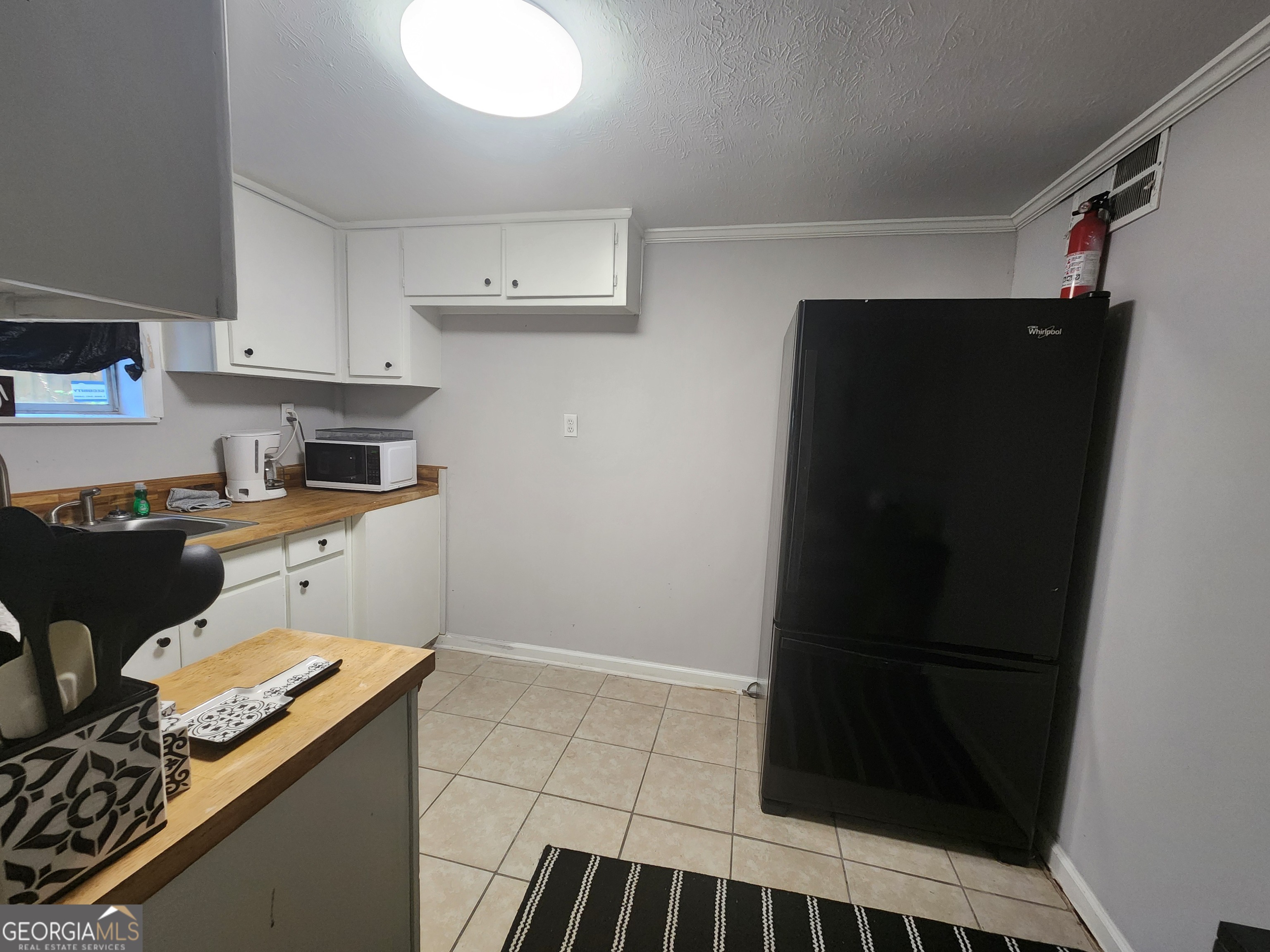 917 Oakview Avenue, Unit E Columbus, GA 31906 - Photo 4 of 13 a kitchen with a refrigerator and a stove top oven