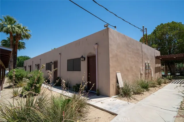 front view of house with potted plants