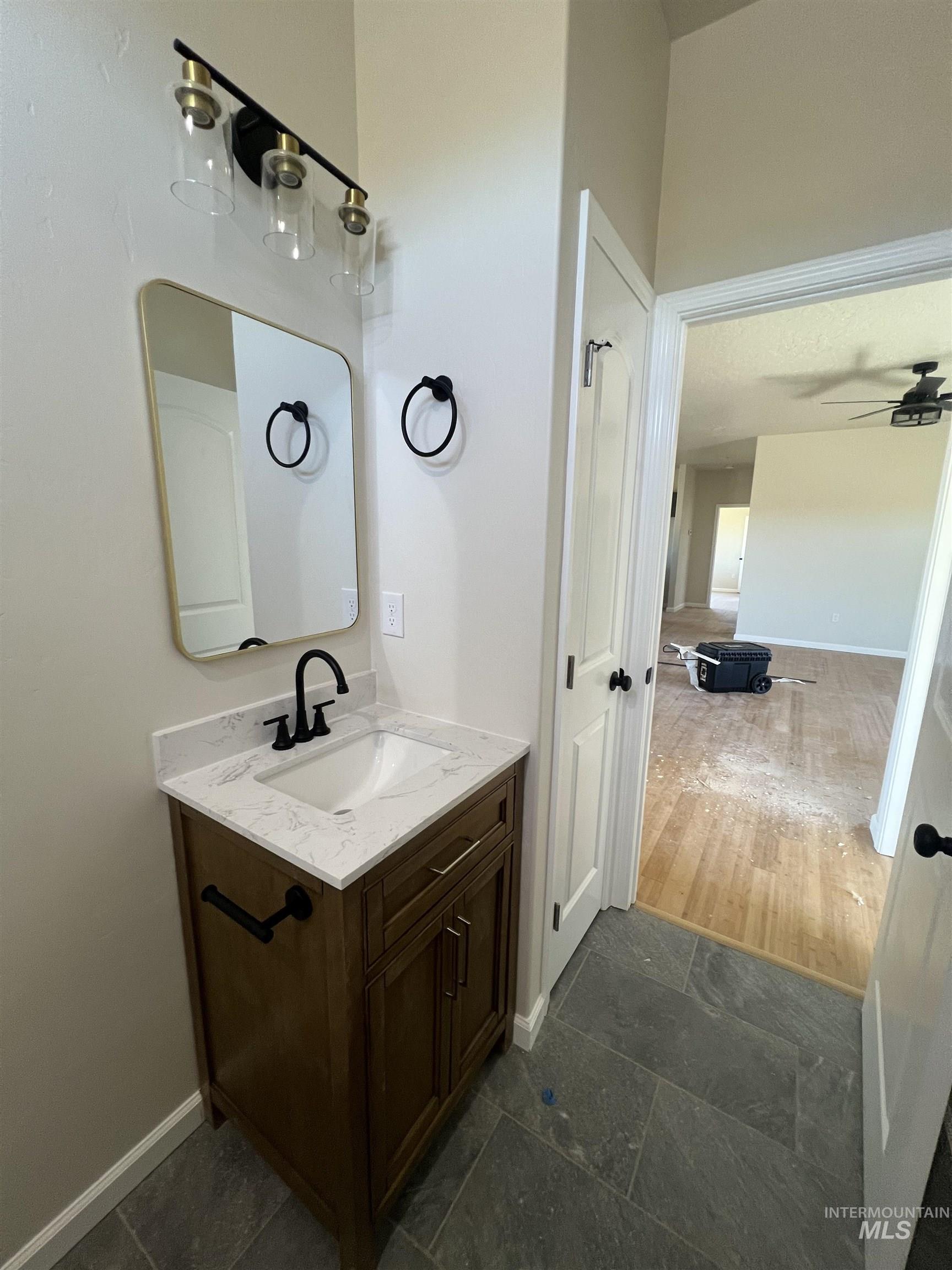 2300 Golf Council, ID 83612 - Photo 12 of 17 Modern vanity featuring a white rectangular sink, a light-toned countertop, and a matte black faucet